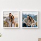 Two framed custom family photographs displayed side-by-side on a white wall, with a white lamp on the right and a green plant on the left.
