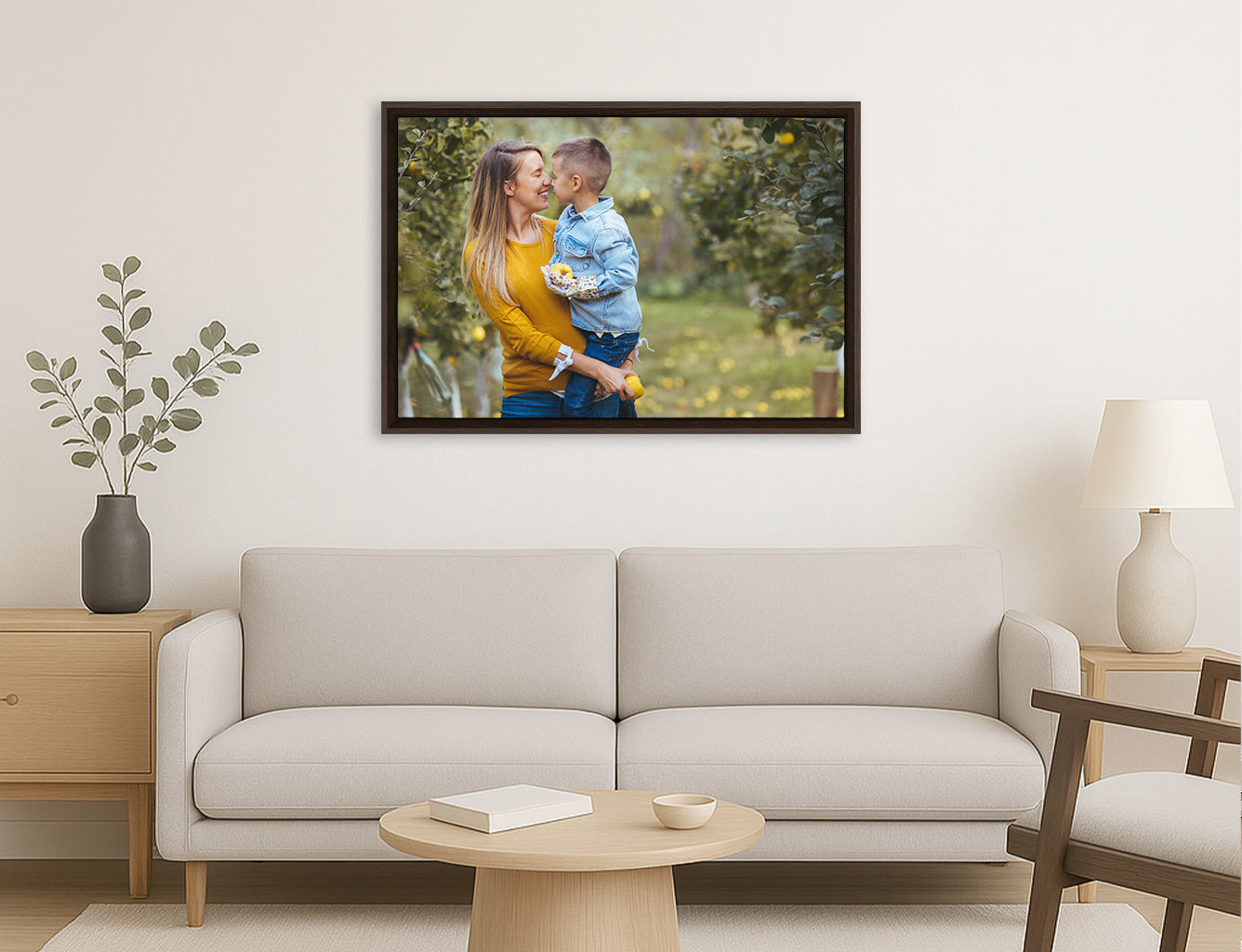 Framed photograph of a couple embracing on a wall above a sofa in a living room.