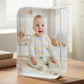 Clear acrylic block with a photo of a baby sitting on a wooden surface.