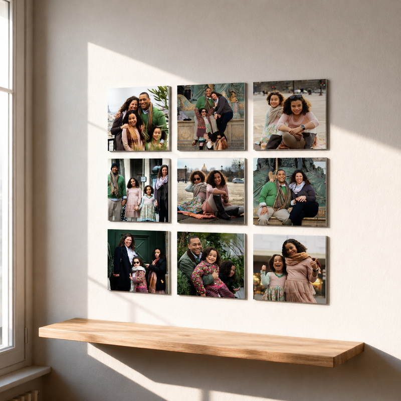 Nine framed family photos on a wall above a wooden shelf.