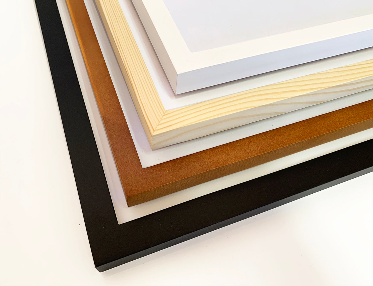 Picture showing the various frames available on Diamond Photo New Zealand. Black Framed Photo and Natural brown, light brown and white.