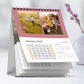 Custom 15 × 20 cm vertical desk calendar with photos, spiral-bound, standing on an office desk