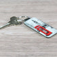 A custom keyring with a leather-look keychain featuring a printed image of a famous red London phone box.