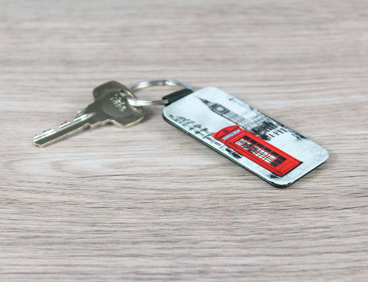 A custom keyring with a leather-look keychain featuring a printed image of a famous red London phone box.