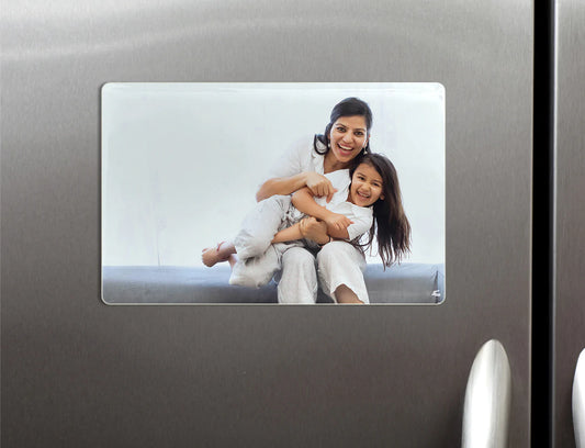A custom porcelain magnet with a photo of a family printed on it, adhered to a metallic surface.