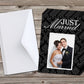 A folded card with a 'Just Married' text and a photo of a couple, placed on a wooden surface. Envelopes are also visible.