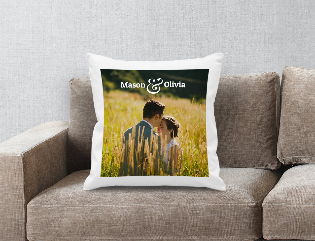 A Personalised Photo Cushion Cover with an image of a couple and their names. Cushion is shown on a sofa.